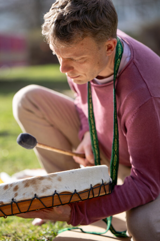 Ein heiliger Atem: Eine Breathwork-Sitzung ist im Gange, wobei ein Therapeut eine Trommel und Kräuter auf einer Decke zur Unterstützung bei der Atemarbeit einsetzt.